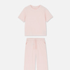 Product photo of a light pink Primark pyjama set with a short sleeved shirt and trousers