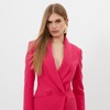 Product photo of a model wearing a bright pink blazer wrap dress